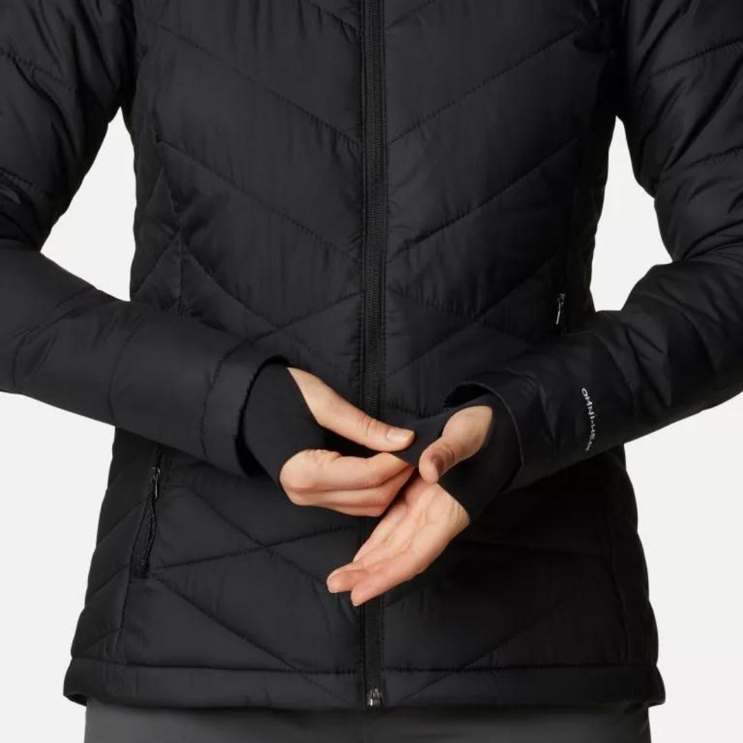 MANTEAU COLUMBIA HEAVENLY HOODED POUR FEMME COULEUR BLACK PORTÉ PAR UNE FEMME VUE EN GROS PLAN SUR LES MAINS DE LA FEMME QUI A LES POIGNET CONFORT SUR LES MAINS