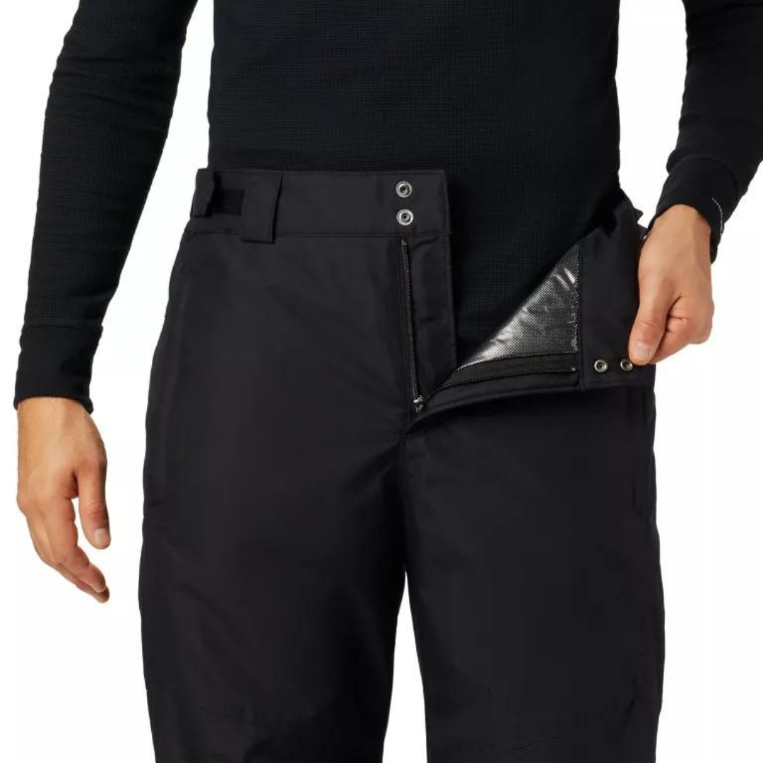 PANTALON DE NEIGE COLUMBIA BUGABOO IV POUR HOMME couleur black porté par un homme vu en gros plan du haut du pantalon l'homme montre une partie de l'intérieur avec la technologie Omni-Heat