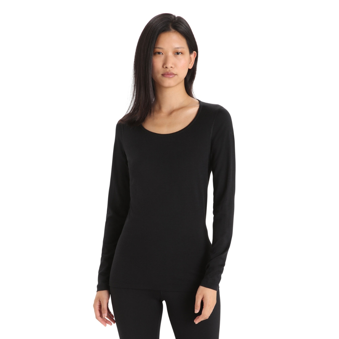 HAUT COUCHE DE BASE ICEBREAKER 200 OASIS ENCOLURE DÉGAGÉE POUR FEMME couleur black porté par une femme vue de face des genoux à la tête chandail encolure ronde à manches longues noir uni