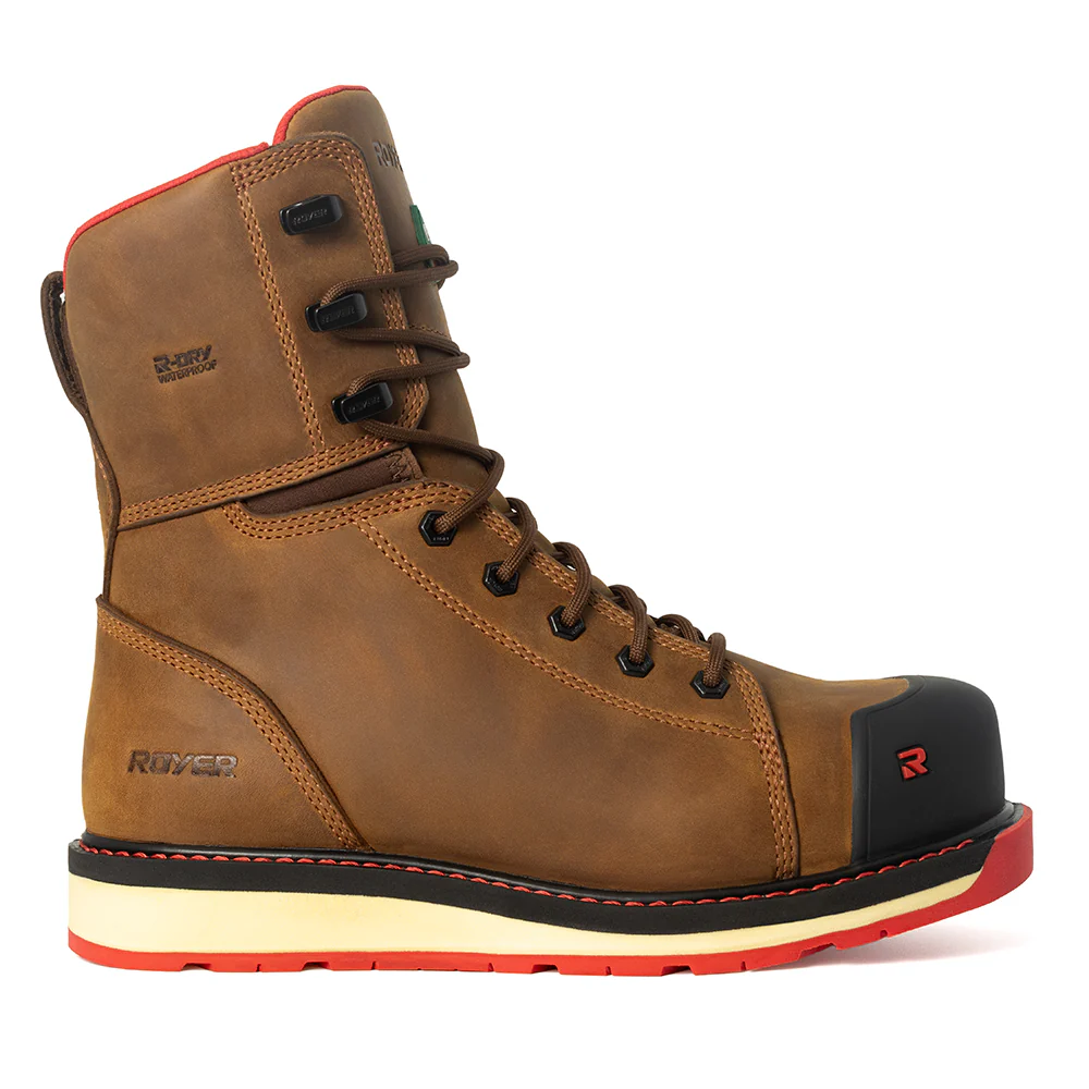 Bottes de travail en cuir marron avec lacets noirs, bout renforcé noir, touches de rouge et semelle épaisse beige et noire. Elles arborent un logo visible et une tige montante.