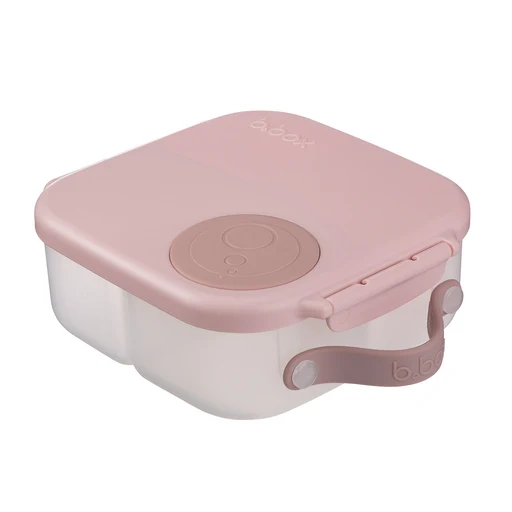 Voici la MINI : une boîte à repas en plastique rose translucide, dotée d'un loquet sécurisé et d'une poignée, avec un motif circulaire sur le couvercle.
