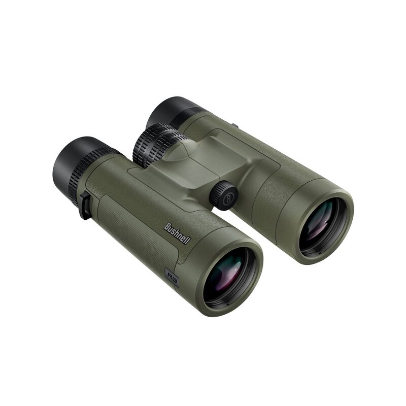 Jumelles Bushnell vertes et noires avec poignée texturée, double oculaire et molette centrale de mise au point, vues de biais sur fond blanc.