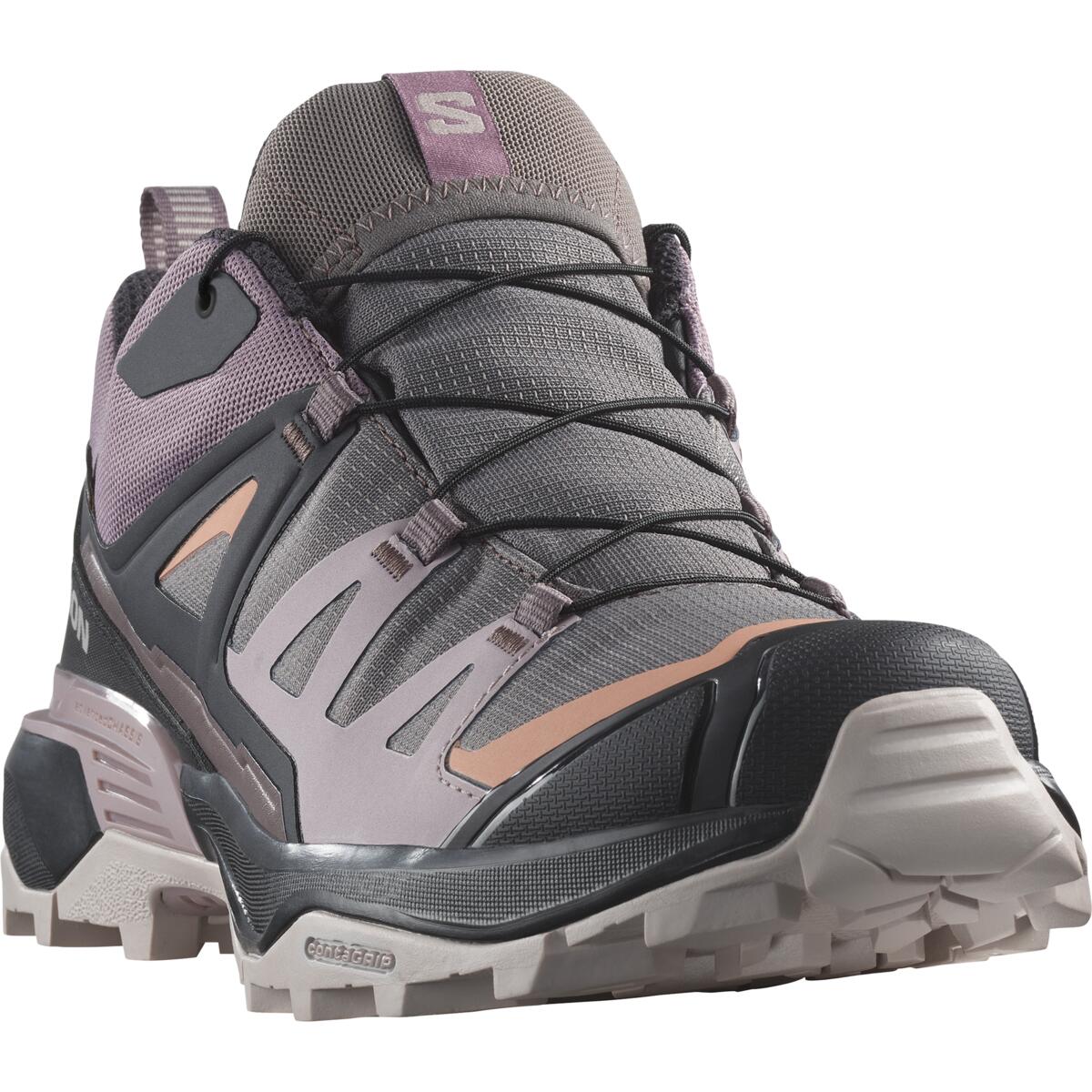 Une chaussure de randonnée robuste, grise et violette, dotée d'un laçage complexe et d'une semelle robuste, conçue pour les terrains extérieurs. La chaussure est dotée d'un embout protecteur et de panneaux latéraux de soutien, mettant en valeur sa construction durable.