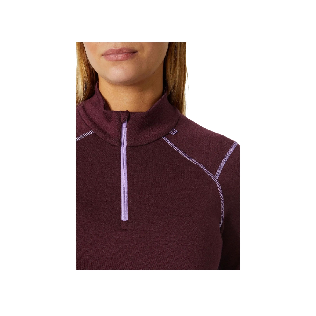 Sous vêtement haut couche de base pour femme demis glissière Helly Hansen couleur Hickory , porté par un femme vue de face qui porte un accent sur la demis glissière.