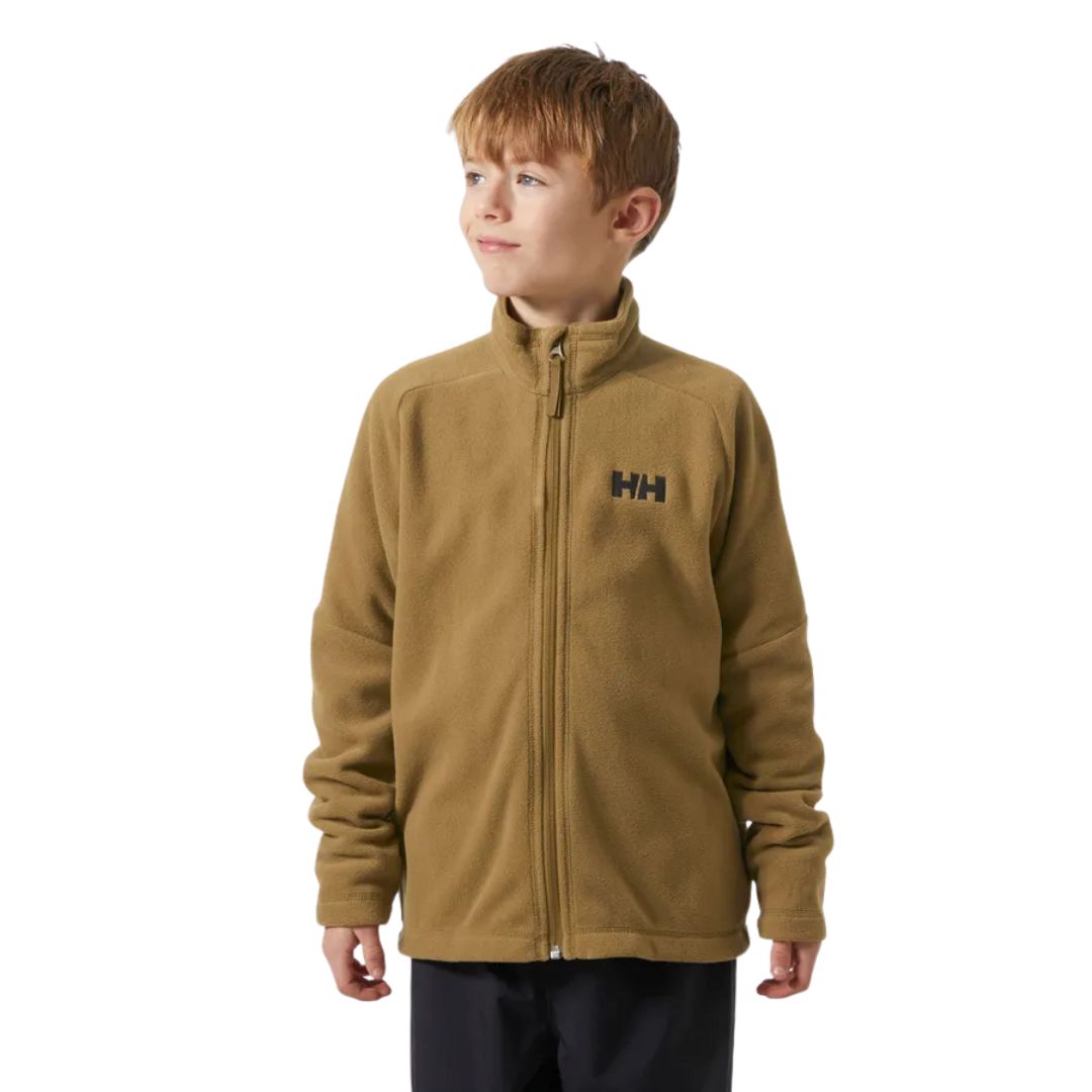 Un jeune garçon aux cheveux châtain clair porte une veste polaire zippée de couleur beige avec un logo "HH" sur la poitrine. Il se tient debout et regarde de côté sur un fond blanc uni.