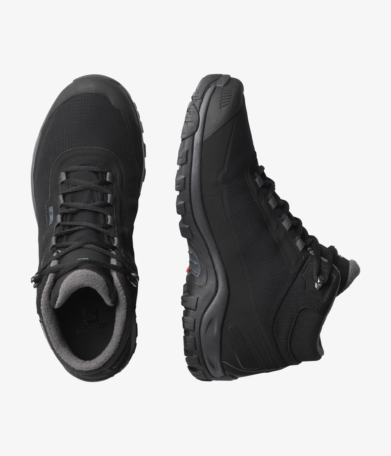 Une paire de bottes de randonnée noires à semelles robustes, vue de côté et de dessus. Les bottes ont des lacets sur le devant et des cols rembourrés, adaptées aux activités de plein air.