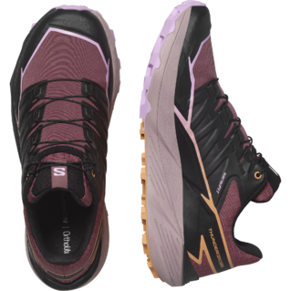Une paire de chaussures de trail running athlétiques aux couleurs marron, noir et rose clair, dotées d'une semelle texturée et d'un design à lacets. Une chaussure est présentée en vue de dessus et l'autre en vue de côté, mettant en valeur son design et son image de marque.