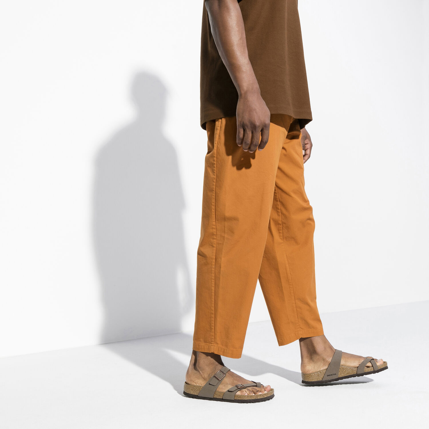 Une paire de sandales Birkenstock Mayari Birkibuc de couleur "Mocha" sur un fond blanc. Les sandales ont deux brides réglables avec des boucles en métal. Les brides sont fabriquées en Birkibuc, un matériau synthétique ressemblant au cuir, doux, durable et facile à nettoyer. Le lit de pied est anatomique en liège et possède une doublure en suède. La semelle extérieure est en EVA, un matériau léger et absorbant les chocs.