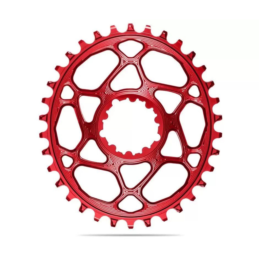 Image d'un plateau de vélo rouge avec un design découpé et élaboré. Le plateau est doté de plusieurs dents pour s'interfacer avec la chaîne du vélo et est affiché sur un fond blanc.