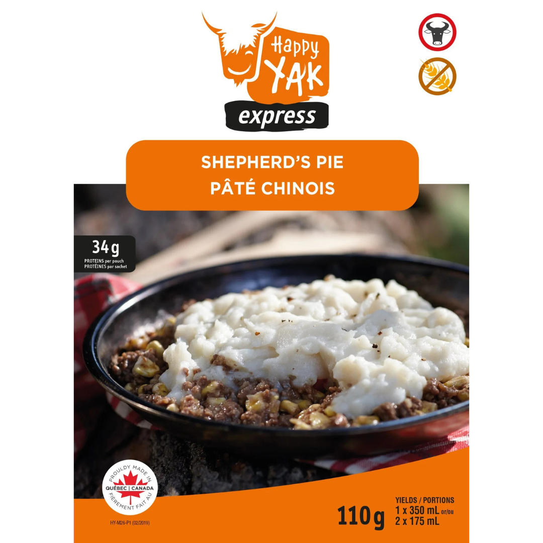 Image de l'emballage du pâté chinois de Happy Yak Express, montrant un gros plan du plat garni de purée de pommes de terre. Les étiquettes indiquent « Pâté chinois » et fournissent des détails sur le poids du produit et la taille de la portion.