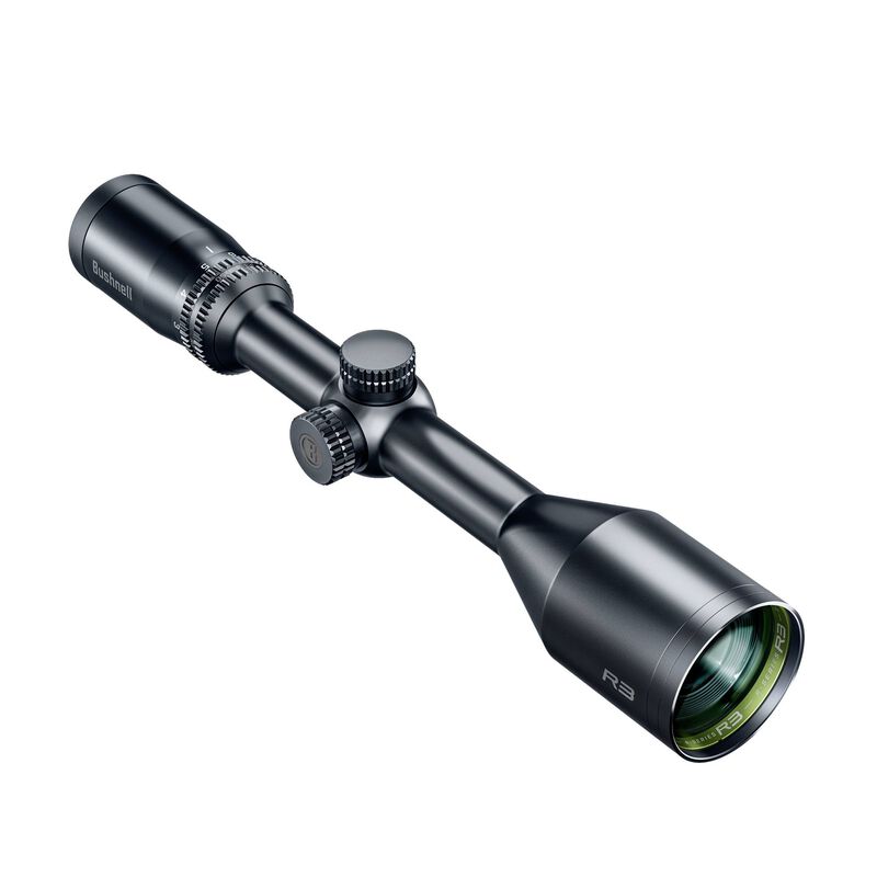 Une lunette de visée noire avec des boutons de réglage et une lentille teintée de vert, étiquetée « Bushnell » et « R3 », présentée sur un fond blanc.