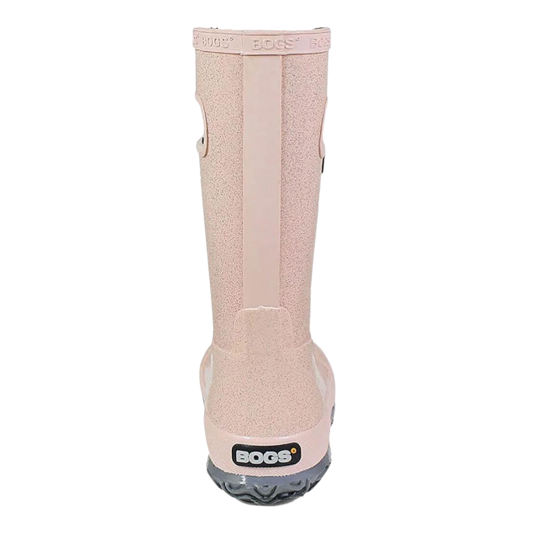 BOTTE DE PLUIE BOGS RAINBOOT GLITTER POUR ENFANT ET JUNIOR couleur rose gold vu de la botte droite de l'arrière la botte rose pale avec des brillants, semelle d'usure grise, le nom logo Bogs en encadré noir au talon, le nom bogs est embossé le long du haut de la tige en bordure