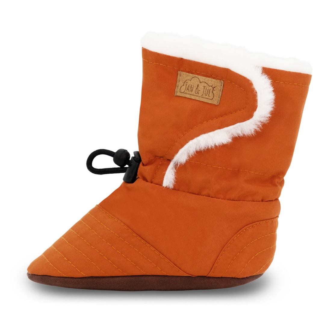 CHAUSSON D'HIVER JAN & JUL STAY-PUT POUR BÉBÉ COULEUR TERRACOTTA VU DU CHAUSSON ORANGE BRULÉ ET BLANC DE PROFI GAUCHE