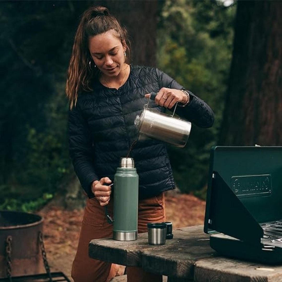 BOUTEILLE ISOTHERME STANLEY LEGENDARY CLASSIC 1.0L couleur hammertone green vue utilisée par une femme qui y verse son café chaud