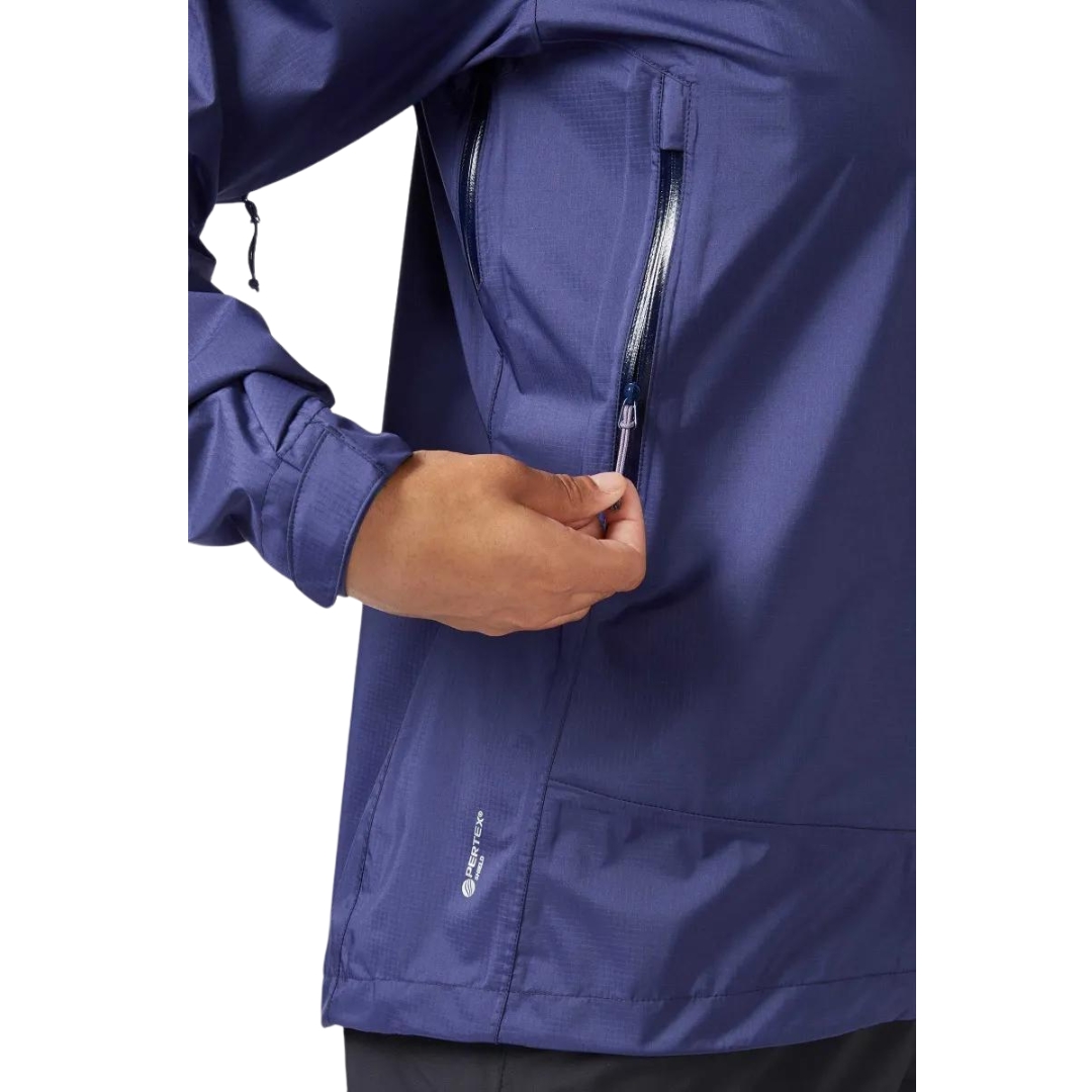 MANTEAU IMPERMÉABLE RAB DOWNPUR PLUS 2.0 POUR FEMME vu couleur PATRIOT BLUE vu du manteau bleu foncé porté par une femme vue en gros plan sur la fermeture éclair de la poche latérale