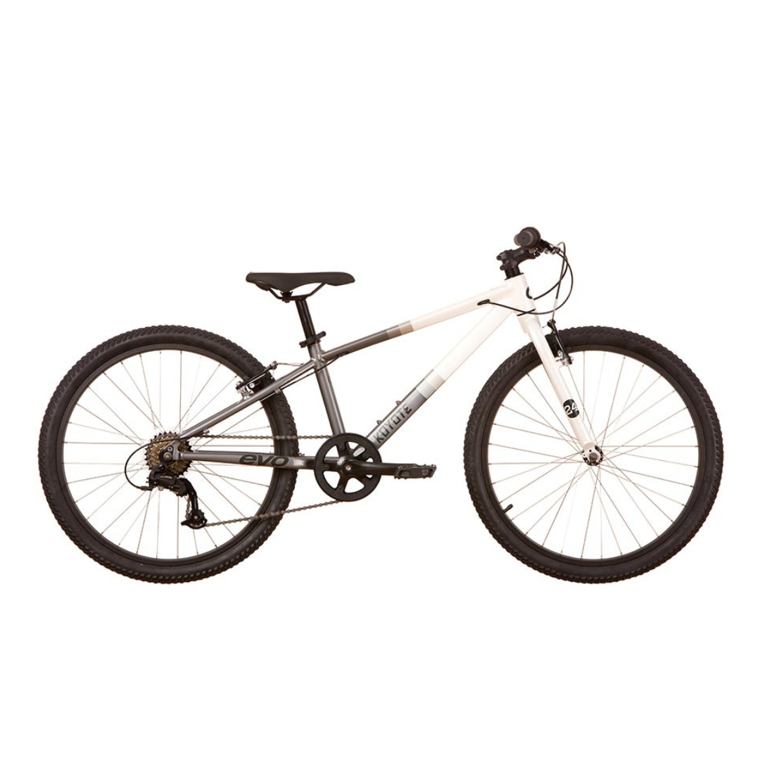 Un VTT blanc et gris avec guidon, selle et pneus noirs est présenté de profil sur fond blanc. Il est équipé d'une fourche à suspension avant et de vitesses arrière.
