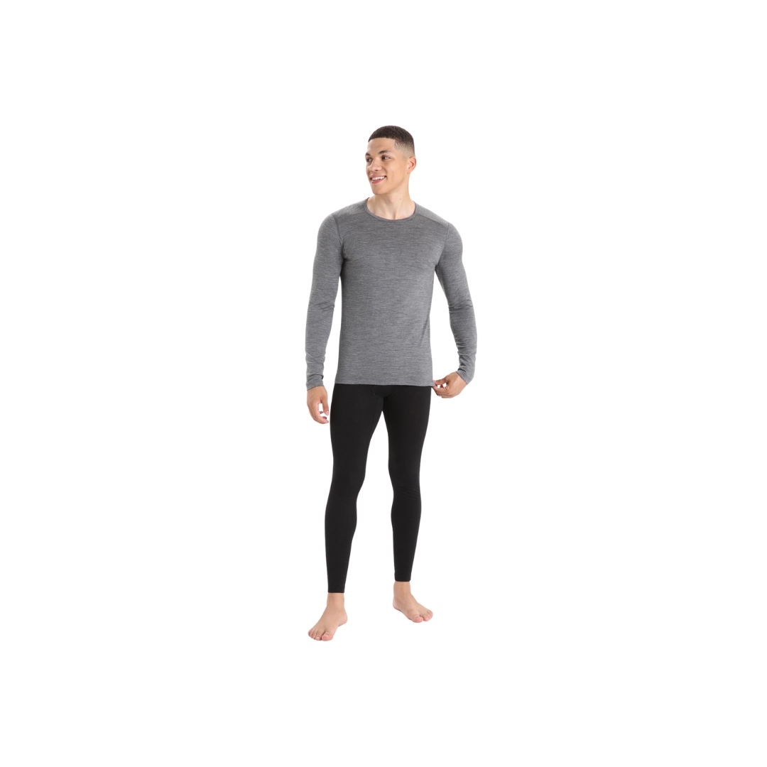 LEGGING COUCHE DE BASE ICEBREAKER AVEC BRAGUETTE 200 OASIS EN MÉRINO POUR HOMME de couloir noir porter par un homme vue de la tête au pied de face