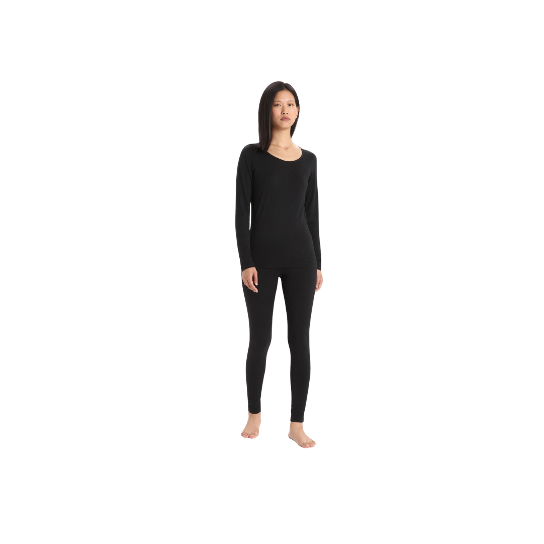 LEGGING COUCHE DE BASE ICEBREAKER 200 OASIS EN MÉRINOS porter par une femme de couloir noir vue de face de la tête au pied